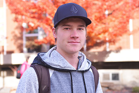 Smiling student with a hat on.